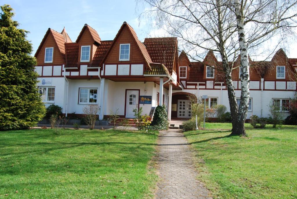 a large house with a pathway in front of it at Ferienwohnung-Zierenberg in Zierenberg