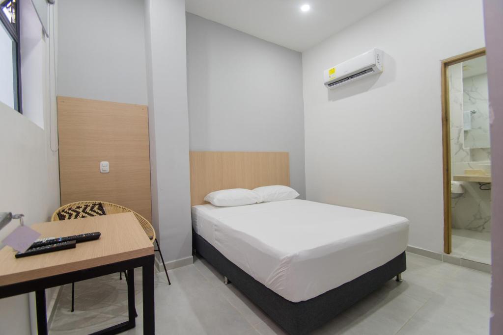 Postel nebo postele na pokoji v ubytování Stanza Hotel Sincelejo