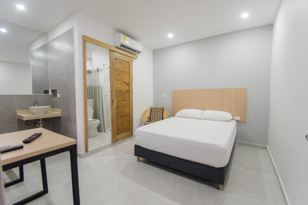 Postel nebo postele na pokoji v ubytování Stanza Hotel Sincelejo
