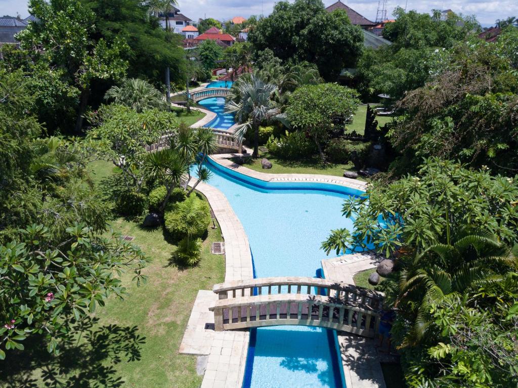 an overhead view of a pool at a resort at The Cakra Hotel in Denpasar