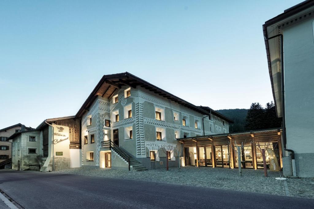 a large building with a staircase in front of it at Chesa Stuva Colani in Madulain