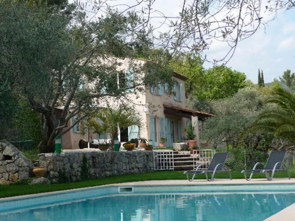 a house with a swimming pool in front of a house at Villa la Grette in Fayence