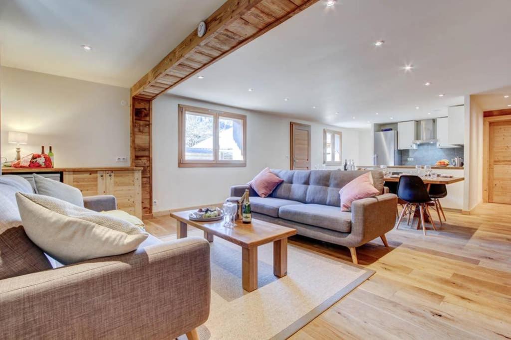 a living room with a couch and a table at Chalet La Petite Grange in Morzine