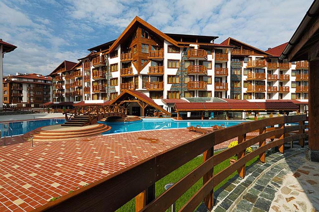a resort with a swimming pool and a large building at Belvedere Holiday Club in Bansko
