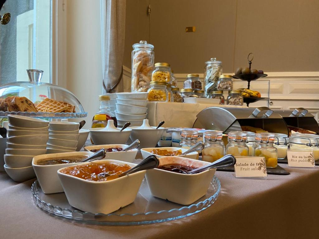 a buffet with bowls of food on a table at Enclos de l&#39;Evêché in Boulogne-sur-Mer