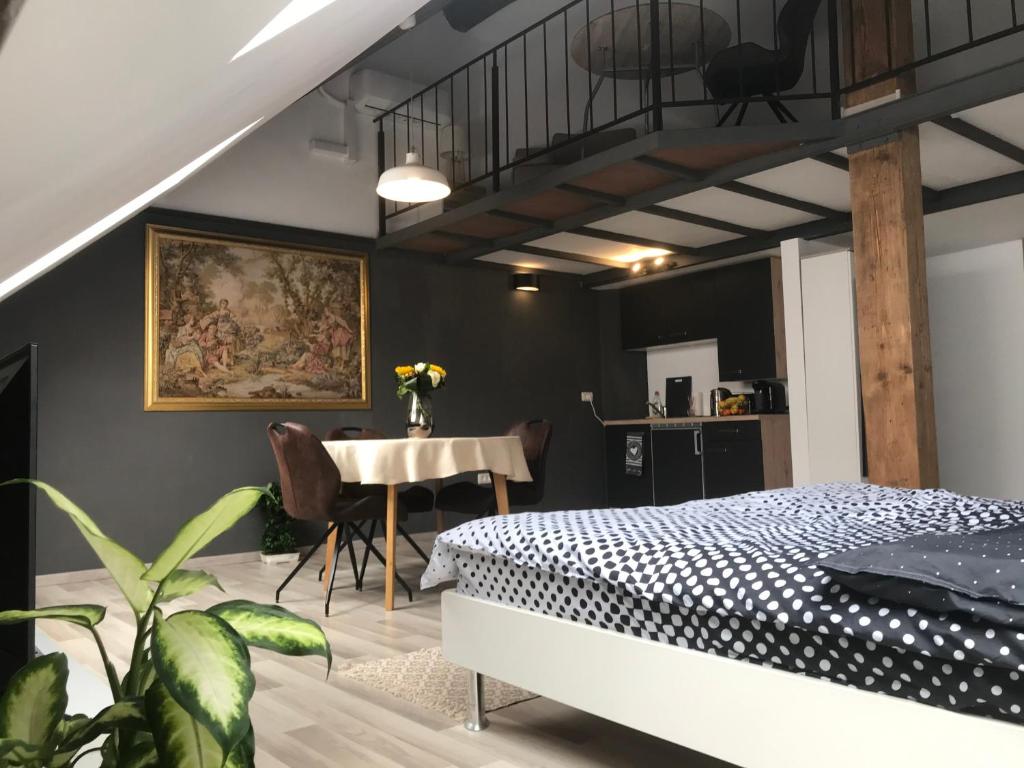 a bedroom with a bed and a dining room table at Savoya nr2 Loft Studio Old City Center Self check-in Workspace in Timişoara