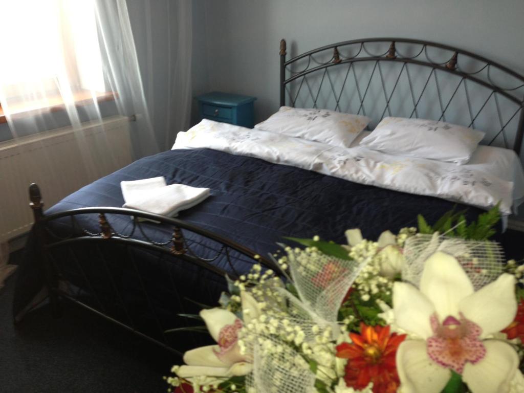 a bedroom with a bed with flowers on it at Capital Riga Apartment - Dzirnavu Street in Riga