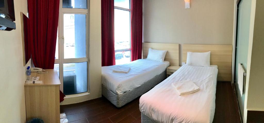 Postel nebo postele na pokoji v ubytování Hotel 18 DIMILIKI OLEH HOTEL MY HOME STATION 18 SDN BHD