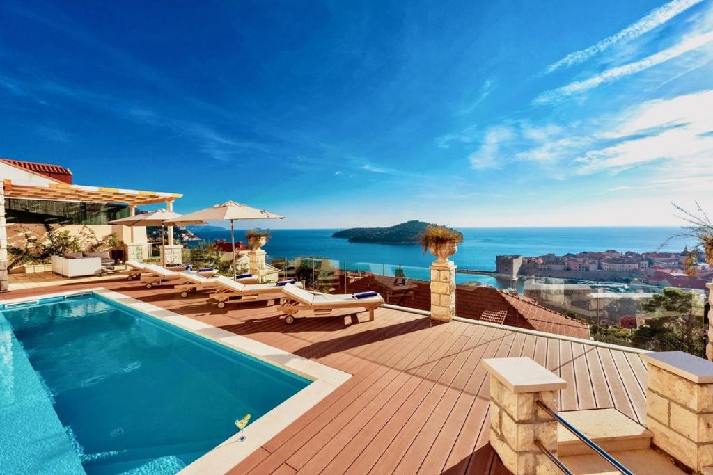 a villa with a swimming pool and a view of the ocean at Villa Vega in Dubrovnik