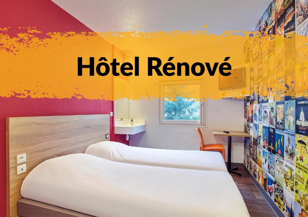 a hotel room with two beds and the words hotel remove at hotelF1 Avranches Baie Du Mont Saint Michel in Saint-Quentin-sur-le-Homme