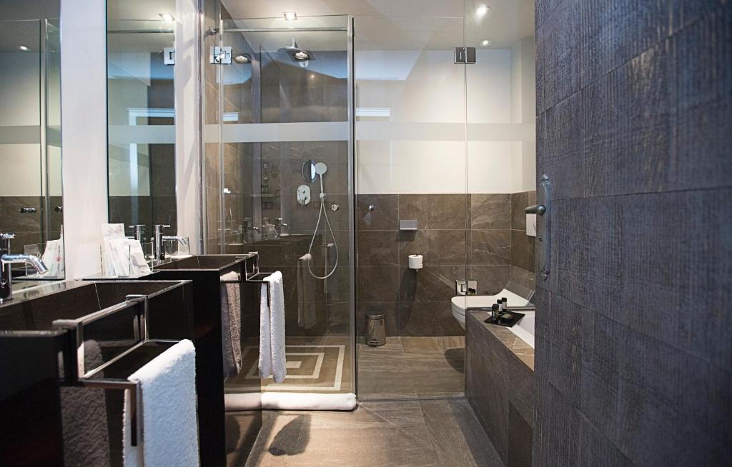 a bathroom with a shower and a sink at Hospes Palacio del Bailio, a Member of Design Hotels in Córdoba