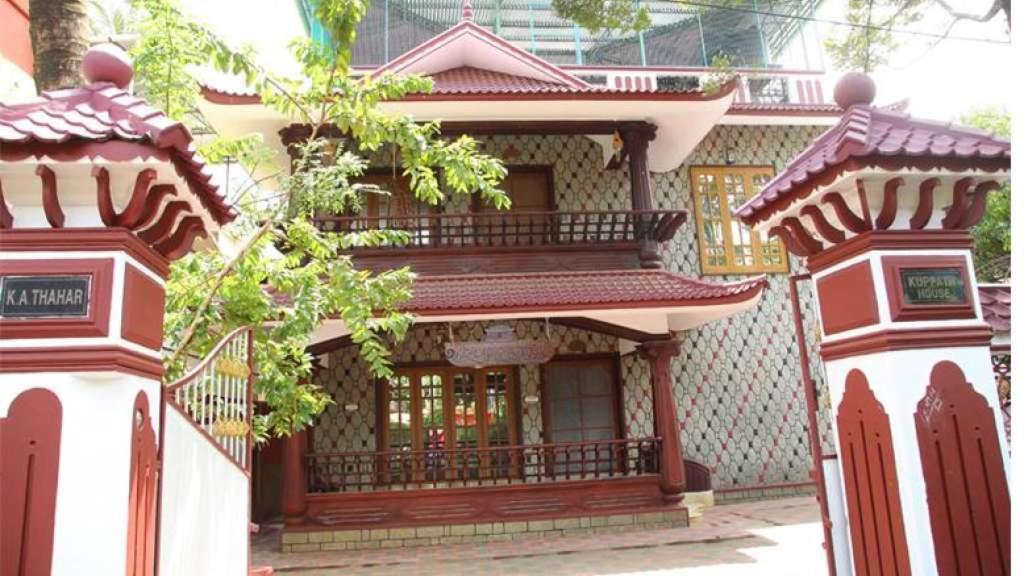 een gebouw met twee pilaren ervoor bij Kuppath Inn in Cochin
