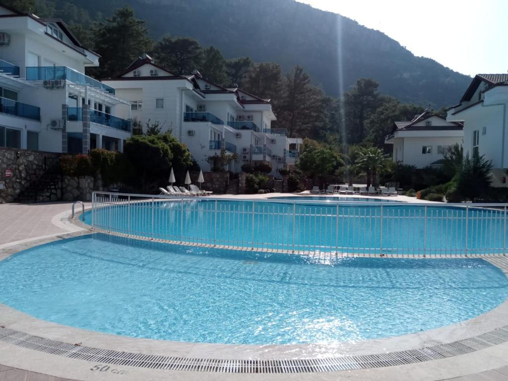 a large swimming pool in front of some buildings at ORKA ROYAL HILLS E4 in Fethiye