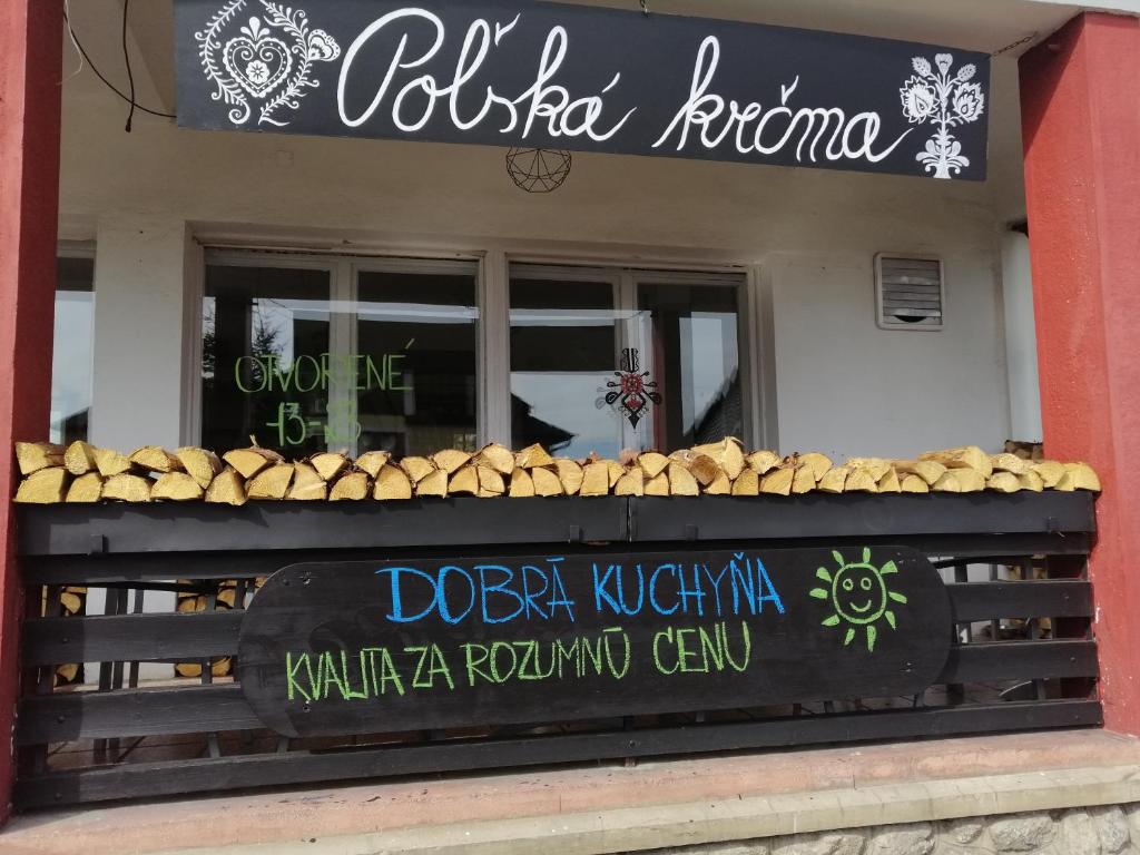 um restaurante com uma placa na frente em POĽSKÁ KRČMA em Vysoke Tatry - Horny Smokovec