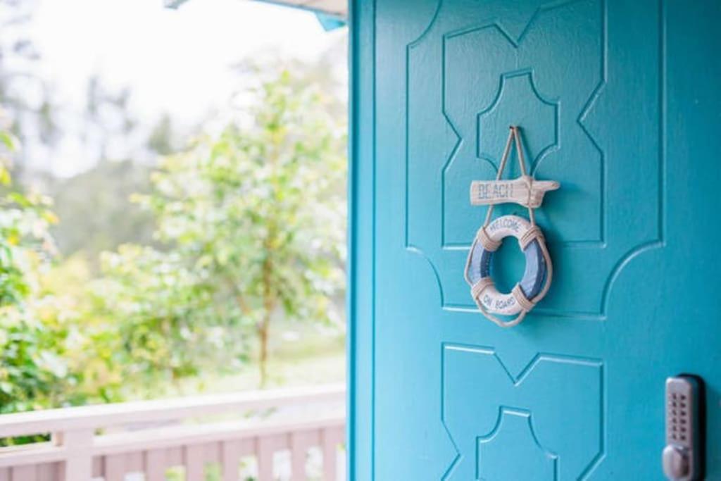 a blue door with a cross and a wreath on it at Central Coast Escape in Point Clare
