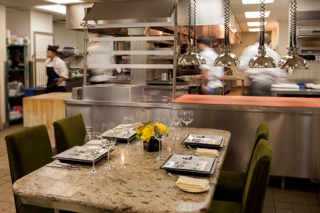 a restaurant with a table with plates and wine glasses at The Rittenhouse Hotel in Philadelphia