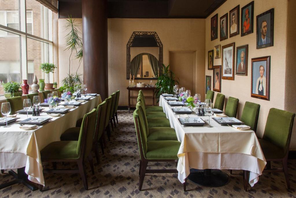a dining room with long tables and green chairs at The Rittenhouse Hotel in Philadelphia