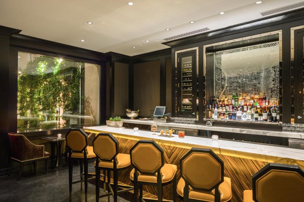 a bar at a restaurant with chairs around it at The Rittenhouse Hotel in Philadelphia