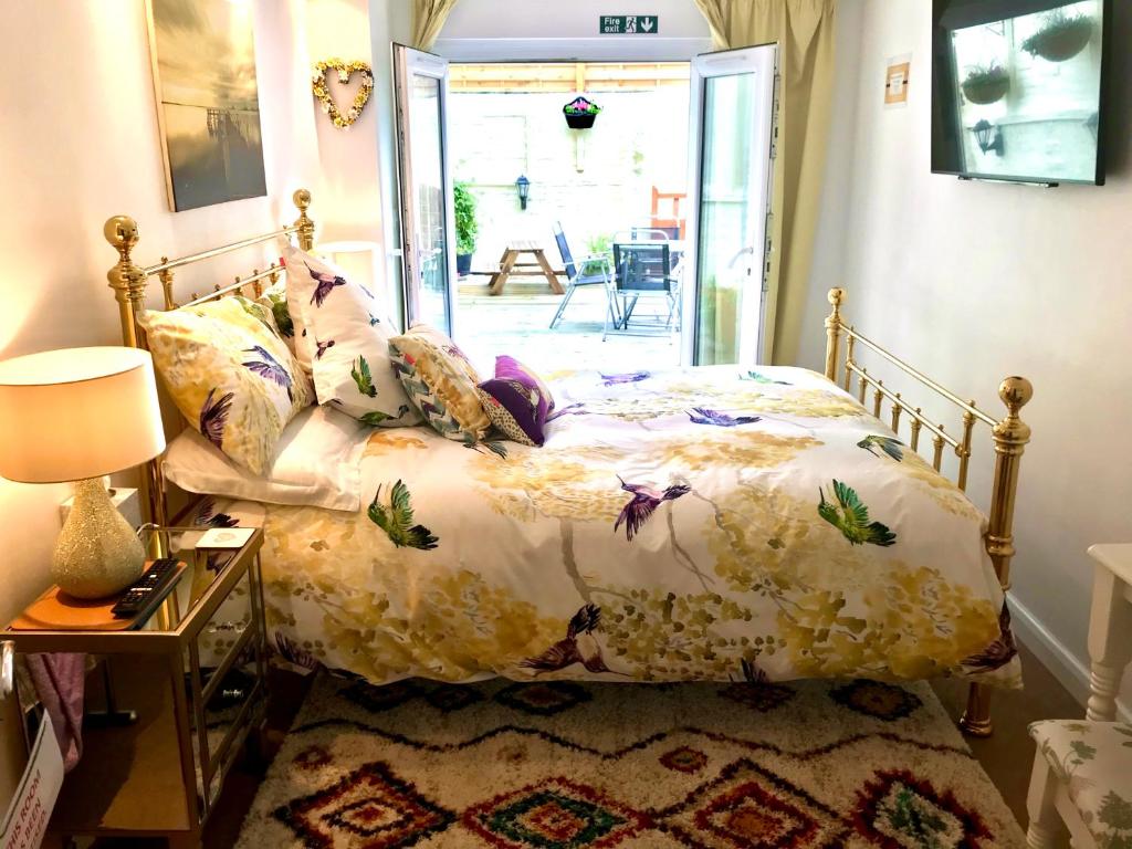 a bedroom with a bed with a floral comforter at The Old Bakery in Cromer