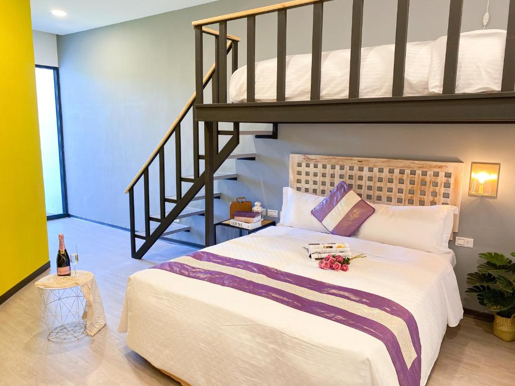 a bedroom with a large bed with a loft at Kenting Sunhow Inn in Kenting