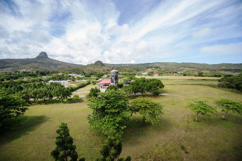 an aerial view of a field with trees and mountains at Kenting Sunhow Inn in Kenting