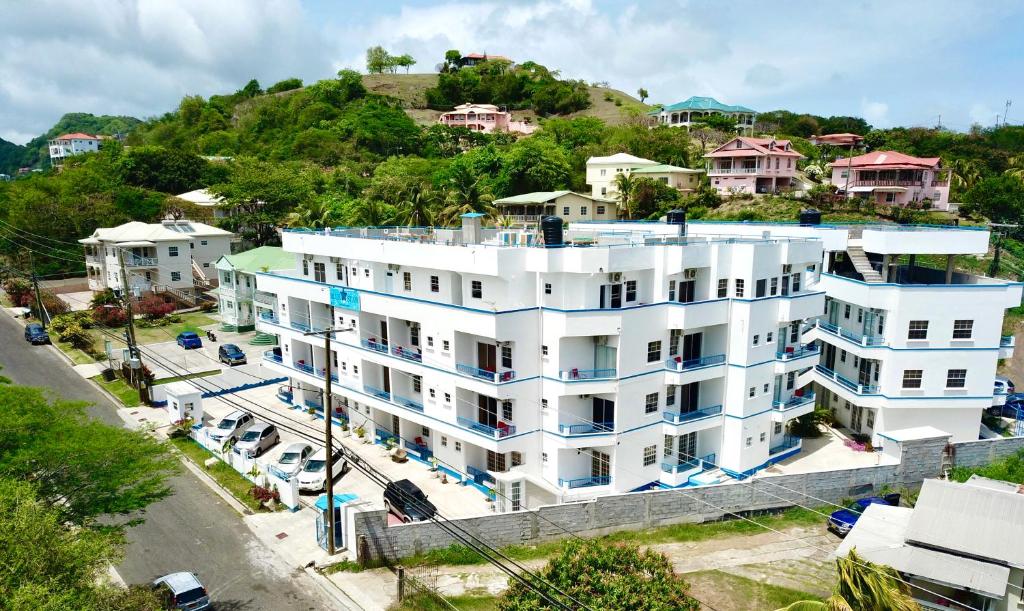 an aerial view of a white building at Blue Star Apartments & Hotel in Lance aux Épines
