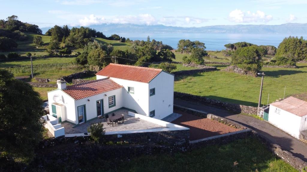 an aerial view of a white house in a field at Casa da Altamora - up to 12 guests! in Cais do Galego