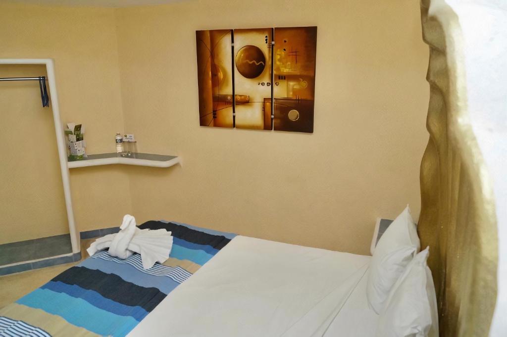 Una cama o camas en una habitación de Hotel Bahia Huatulco