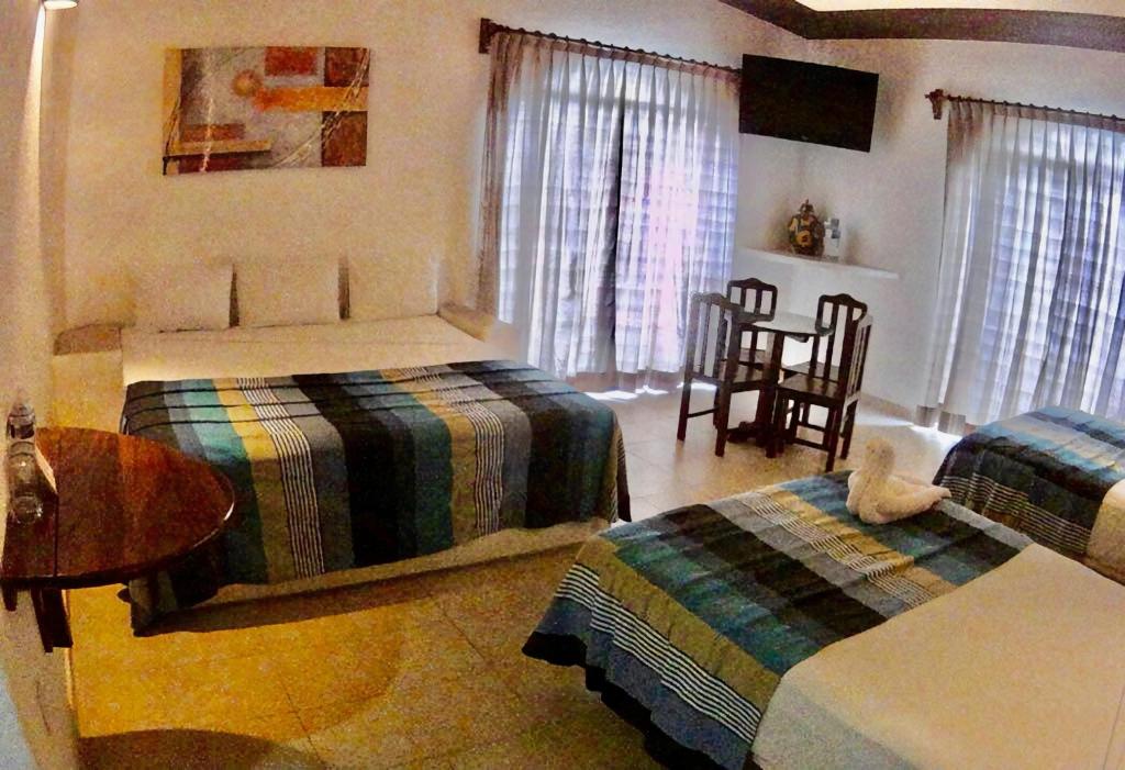 Una cama o camas en una habitación de Hotel Bahia Huatulco