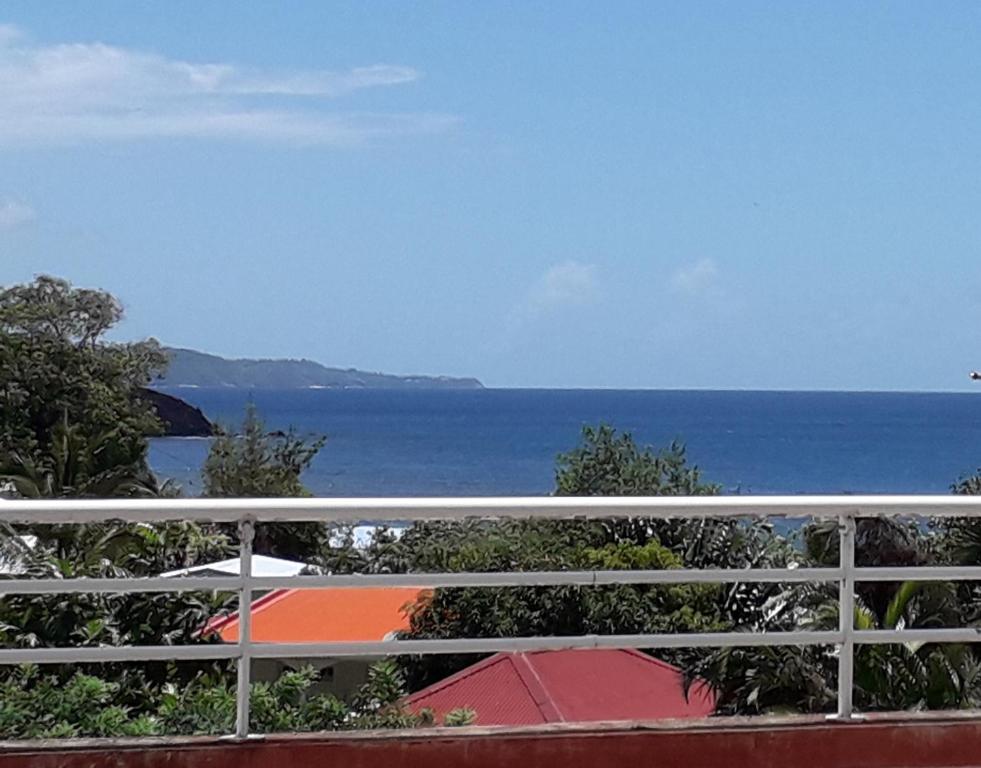 a view of the ocean from a balcony at Appartement Colibri de la Baie de Tartane in La Trinité