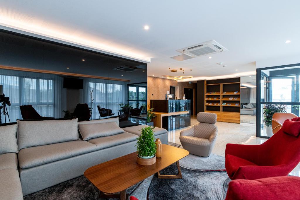 a living room with a couch and chairs and a table at Woods Genève-Thoiry in Thoiry