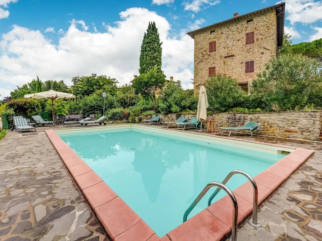 a swimming pool in front of a building at Belvilla by OYO Welcoming Holiday Home with Pool in Monterchi