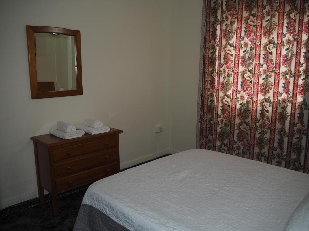 A bed or beds in a room at apartamentos la villa 2