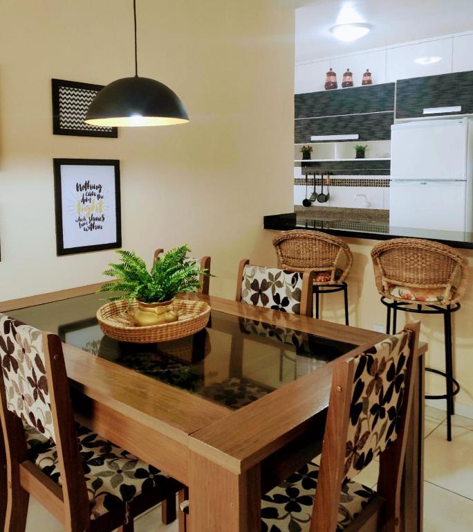 a dining room with a glass table and chairs at Apto 2 quartos em Arroio do Silva in Arroio do Silva