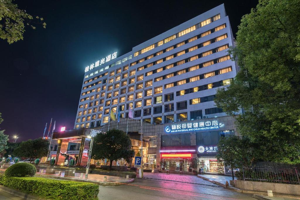 a lit up hotel building at night at Guilin Plaza Hotel in Guilin