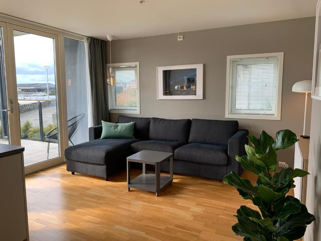 a living room with a couch and a table at Modern apartment in the Harbour of Jørpeland in Jørpeland