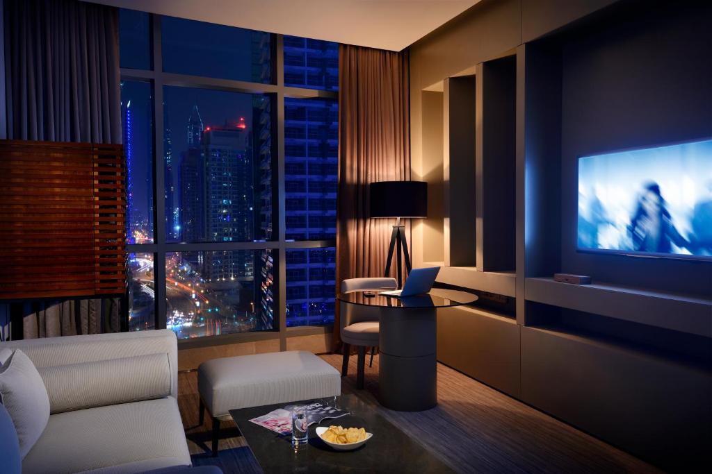 a hotel room with a view of a city at night at InterContinental Dubai Marina by IHG in Dubai