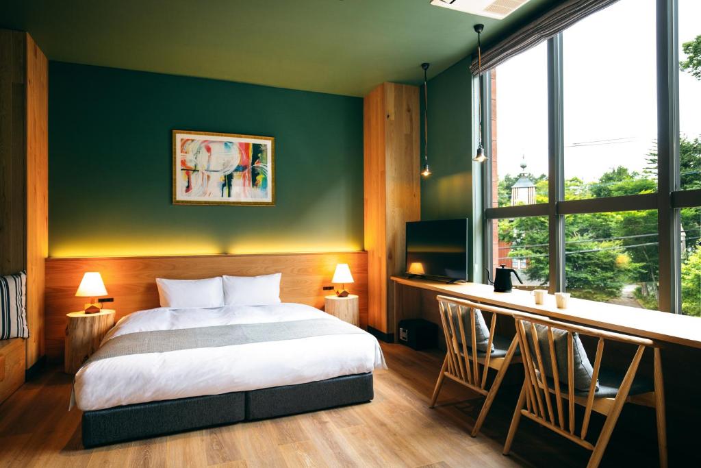 Postel nebo postele na pokoji v ubytování HOTEL KARUIZAWA CROSS
