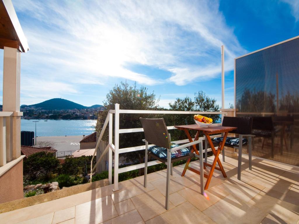 un patio con tavolo e sedie sul balcone. di Apartments F & P a Dubrovnik