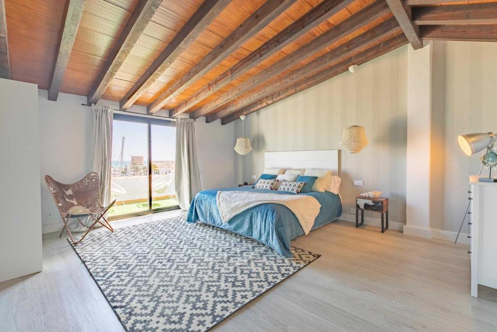 a bedroom with a bed and a large window at VACATION MARBELLA I Stylish 5BDR Penthouse, Sea and Marina View in Marbella