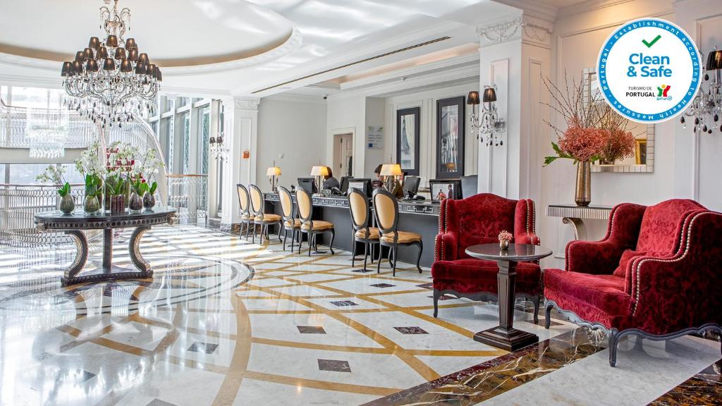 a lobby with red chairs and a barber shop at InterContinental Porto - Palacio das Cardosas by IHG in Porto