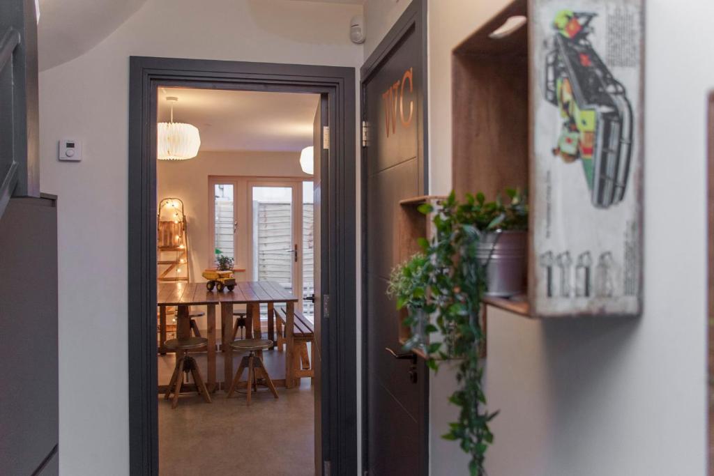 a hallway with a door open to a dining room at higgihaus #3b 4 Bed Monday - Friday Whole House in Bristol