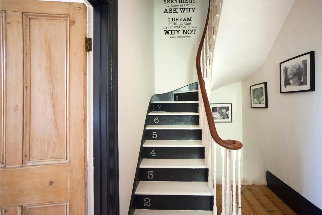 a staircase in a house with a sign on the wall at higgihaus #46 5 Bed Monday - Friday in Bristol