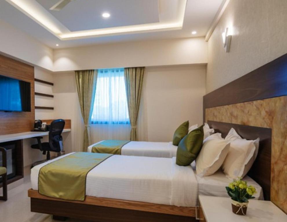Postel nebo postele na pokoji v ubytování Hotel Kheni