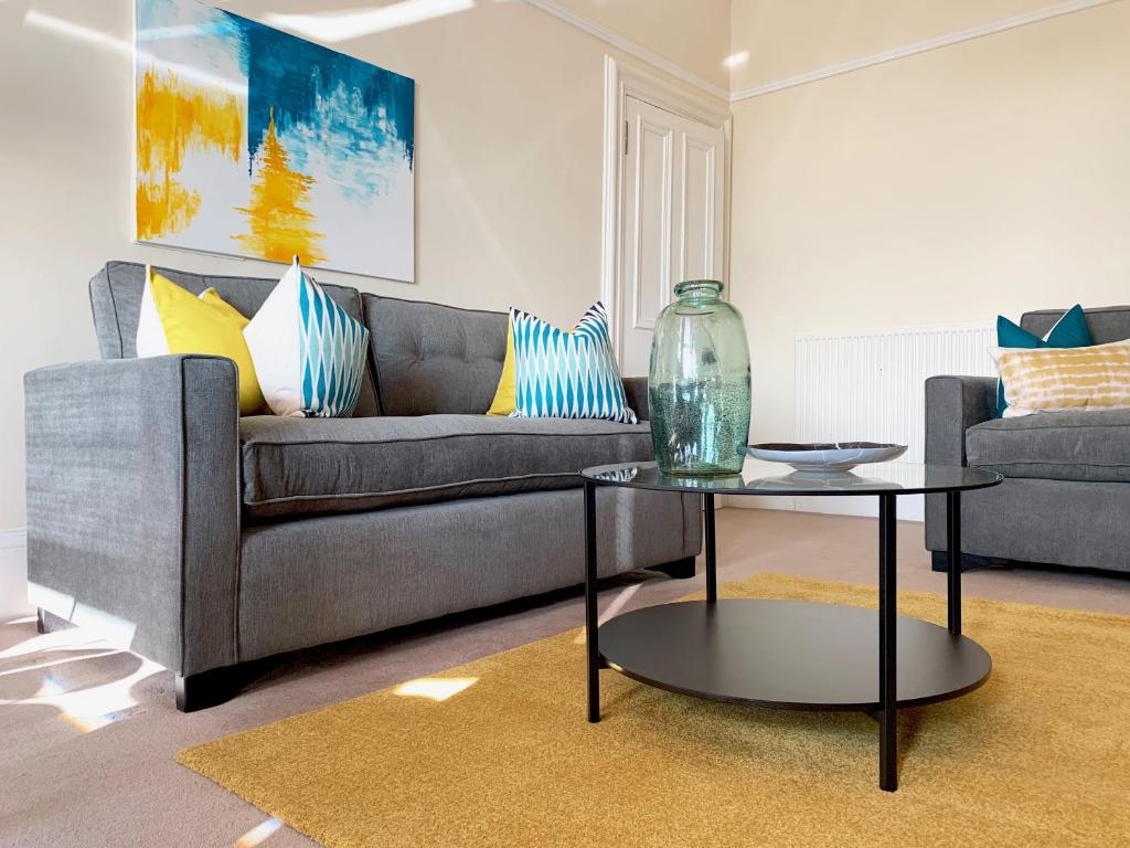 uma sala de estar com um sofá e uma mesa em Tay View Apartment em Dundee