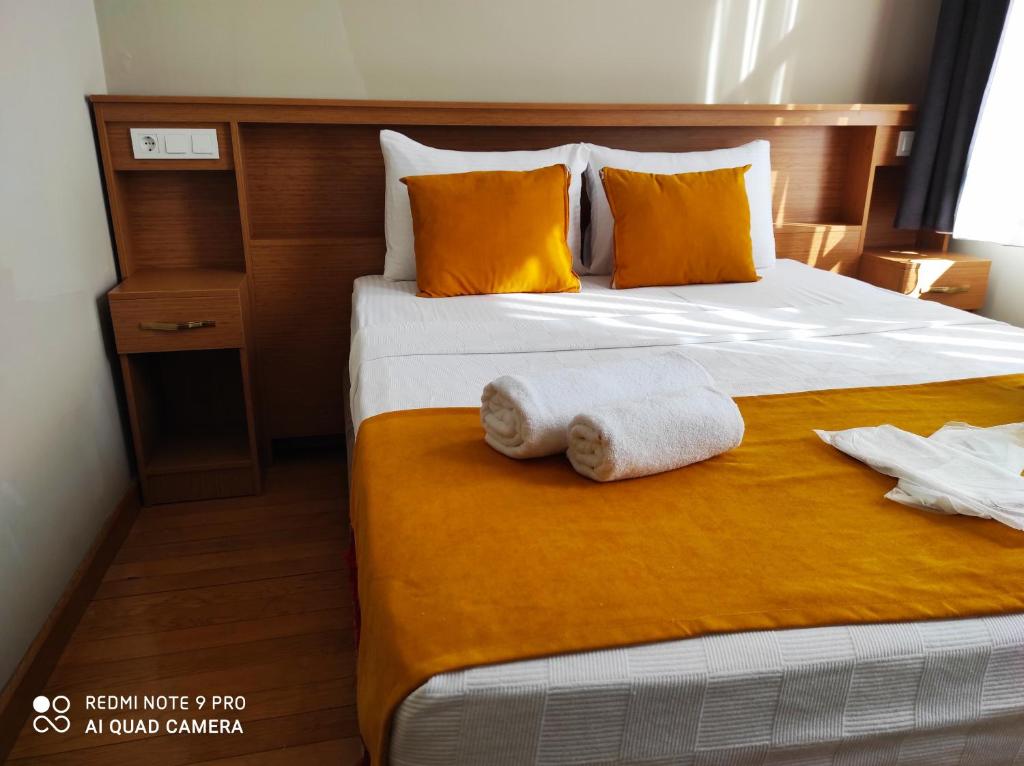 a bedroom with a bed with two towels on it at Lebon Hotel-Special Class in Istanbul