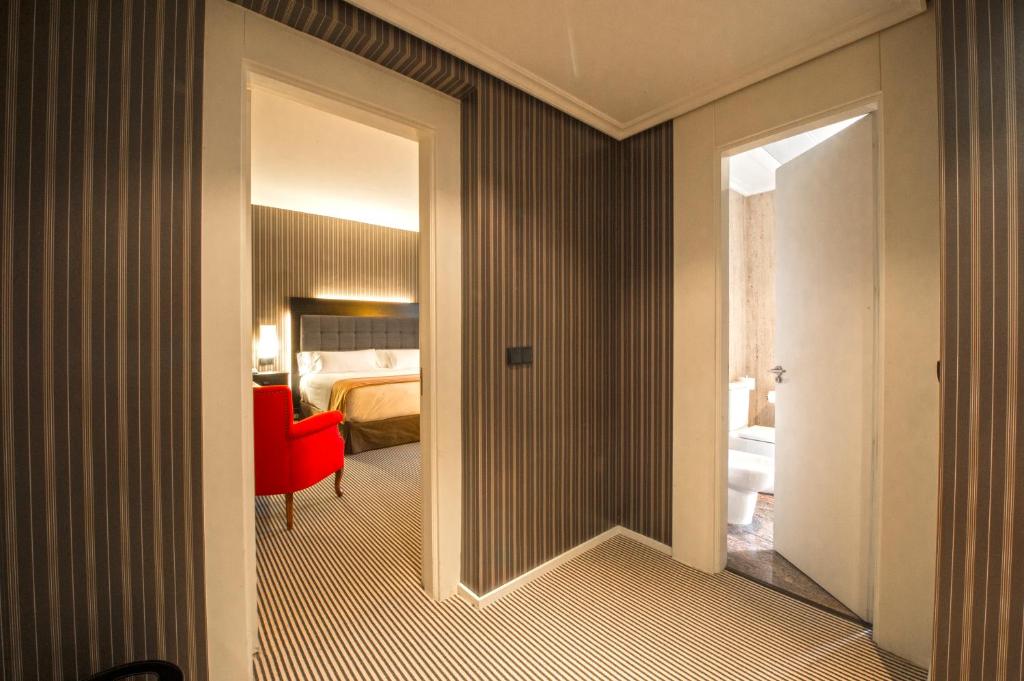 Postel nebo postele na pokoji v ubytování Silken Gran hotel Durango