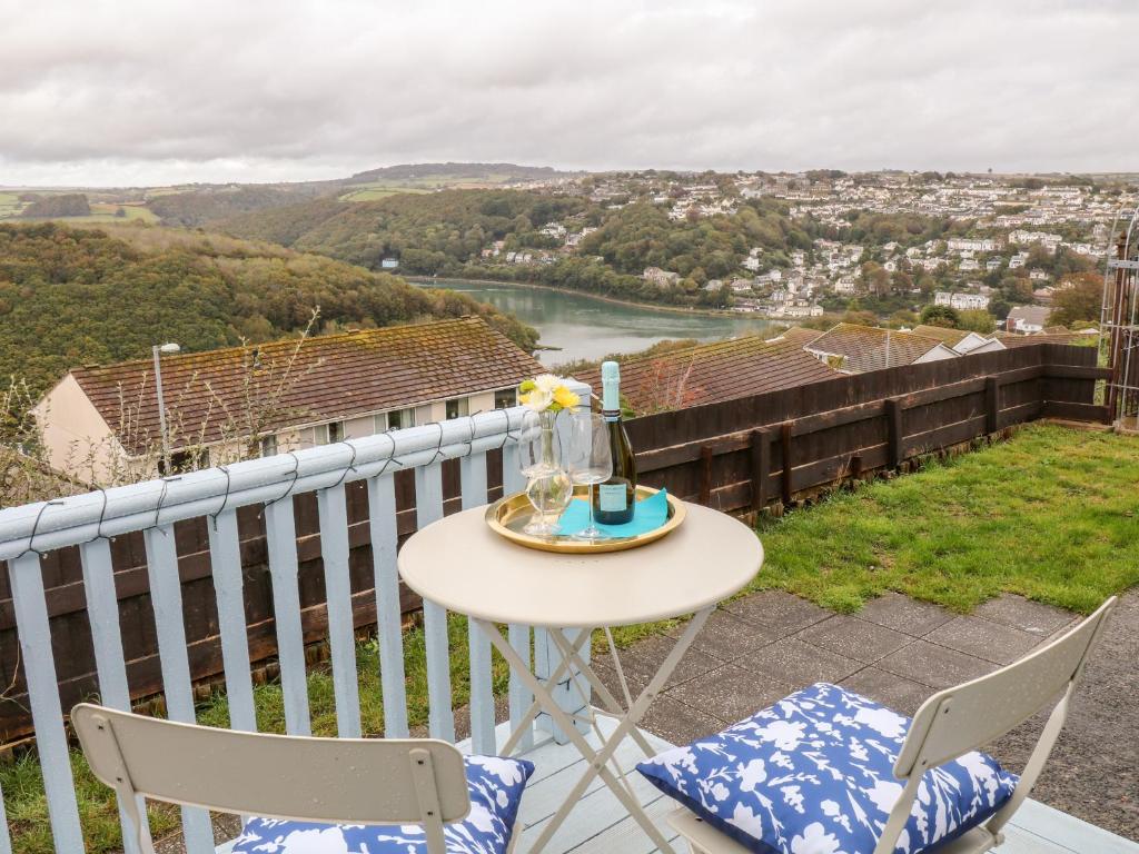 a table and two chairs on a balcony with a view at Gull's View in Looe