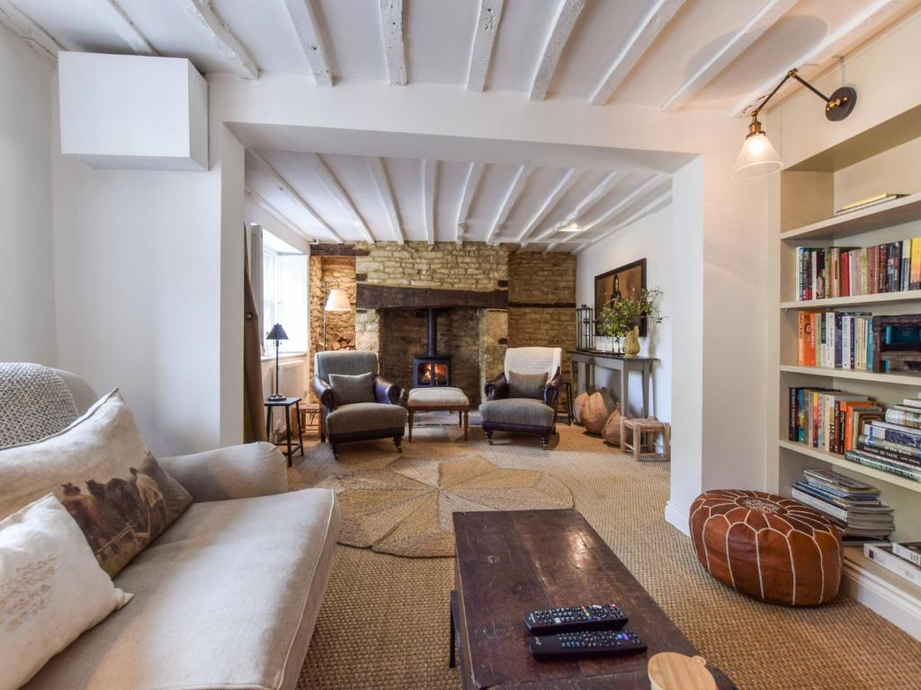 a living room with a couch and a fireplace at Browns Cottage in Chipping Norton