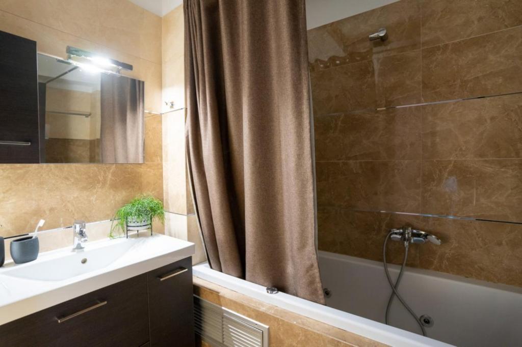a bathroom with a sink and a shower at Meteora 360 Apartment by Meteora Residencies in Kalabaka